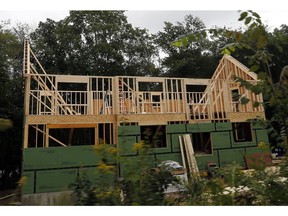 In this Tuesday, Aug. 21, 2018 photo, a new home is under construction in Andover, Mass. On Thursday, Aug. 23, The Commerce Department reports on sales of new homes in July.