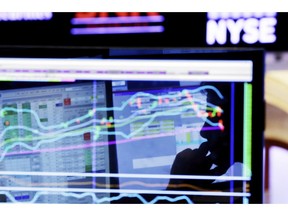 FILE - In this Jan. 11, 2016, file photo, specialist Anthony Rinaldi is silhouetted on a screen at his post on the floor of the New York Stock Exchange. The economy is growing, the stock market is soaring and unemployment remains low. It's the perfect time to prepare for the worst.