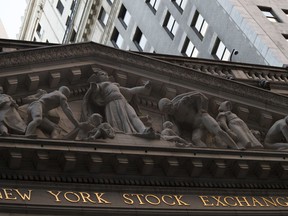 FILE- This Oct. 25, 2016, file photo shows the New York Stock Exchange at sunset in lower Manhattan. On Monday, Aug. 6, 2018, stocks are opening slightly lower on Wall Street as the market gives back some of its gains from the week before.