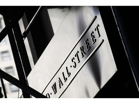 FILE - This July 15, 2013, file photo, shows a sign for Wall Street outside the New York Stock Exchange. The U.S. stock market opens at 9:30 a.m. EDT on Monday, Aug. 20, 2018.