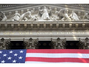 FILE- In this July 6, 2015, file photo, an American flag is draped on the exterior of the New York Stock Exchange. The U.S. stock market opens at 9:30 a.m. EDT on Wednesday, Aug. 22, 2018.