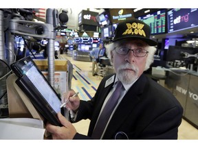 Trader Peter Tuchman wears a "Dow 26,000" hat as he works on the floor of the New York Stock Exchange, Monday, Aug. 27, 2018. The Dow Jones Industrial Average jumped 208 points, or 0.8 percent, to 26,002.