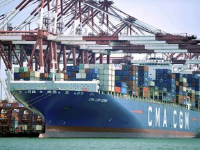 a container ship is docked at a port in Qingdao, in eastern China's Shandong Province. President Trump is to have a summit in mid-March with China's Xi Jinping on bilateral trade.