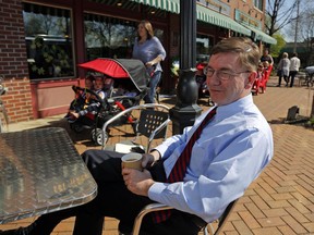 In this May 1, 2018 file photo Republican Rep. Keith Rothfus sits outside a coffee shop in downtown Beaver, Pa. A congressman since 2013, Rothfus faces a tough re-election battle in Pennsylvania's newly created 17th District against Democrat Conor Lamb, who won a special election House victory earlier this year.