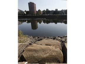 On of the so called "hunger stones" exposed by the low level of water in the Elbe river in Decin, Czech Republic, Thursday, Aug. 23, 2018. The low level of water caused by the recent drought has exposed some stones at the river bed whose appearances in history meant for people to get ready for troubles. They are known as the "hunger stones" and they were chosen in the past to record low water levels.