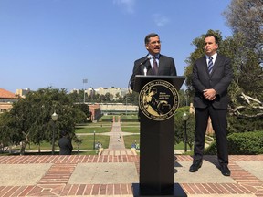 California Attorney General Xavier Becerra speaks at UCLA about his efforts to fight the Trump administration's proposal to weaken car efficiency fuel standards in Los Angeles on Thursday, Aug. 2, 2018. Deputy Attorney General David Zaft is on the right.
