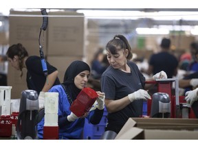 FILE - In this Sept. 2, 2015 file photo, employees work at the SodaStream factory near the Bedouin city of Rahat, Southern Israel. Beverage giant PepsiCo has bought Israel's fizzy drink maker SodaStream for $3.2 billion. PepsiCo said on Monday, Aug. 20, 2018, that it is acquiring all SodaStream's outstanding shares at $144 per share, a 32 percent premium to the 30-day volume weighted average price.