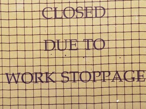 A sign on a school closed due to work stoppage.