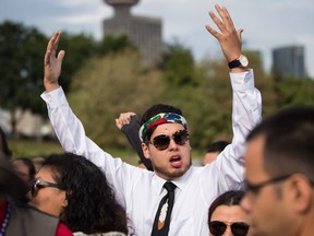Cedar George-Parker raises his arms and cheers before First Nations leaders respond to a Federal Court of Appeal ruling on the Kinder Morgan Trans Mountain Pipeline expansion, during a news conference in Vancouver, on Thursday August 30, 2018.