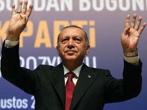 Turkey's President Recep Tayyip Erdogan gestures prior to delivering a speech in Ankara, Turkey, Tuesday, Aug. 14, 2018. Erdogan said his country will boycott U.S.-made electronic goods amid a diplomatic spat that has helped trigger a Turkish currency crisis.