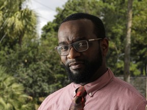 In this Aug. 17, 2018, photo Marcus Harris poses at his home in Spring, Texas. Harris, a 34-year-old physician in the Houston area who started investing about five years ago. "It's going to sound terrible, but I'm actually looking forward to the next downturn," he said of the opportunity to buy stocks at a lower price. "I know it's an overbought position right now, and I'm just sitting on my hands saying, 'I can't wait.' Hopefully it will go to half the price, and I can gobble up a lot of it."