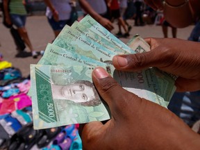 Venezuelan bolivar bills. The official rate for the currency will go from about 285,000 per dollar to 6 million, a shock that officials tried to partly offset by raising the minimum wage 3,500 per cent to the equivalent of just US$30 a month.
