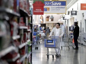 A man pushes a cart while shopping at a Walmart store in North Bergen, N.J. Walmart Inc. reports earnings on Thursday, Aug. 16, 2018.
