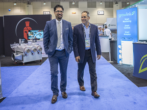 Soheil Samimi, left, walks the floor at the MJ BizCon International tradeshow in Toronto.