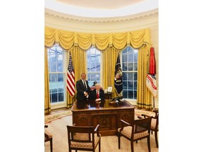 This image from the website of Allied Wallet CEO Ahmad "Andy" Khawaja shows Khawaja posing with President Donald Trump in the Oval Office of the White House in Washington. Khawaja gave more than $4 million to Hillary Clinton's failed presidential campaign and other Democrats, then began extending his largesse to Republicans after a lunch with GOP fundraiser Elliott Broidy two weeks after Trump clinched the presidency. Records obtained by The Associated Press show that Khawaja has helped pornographers, payday loan debt collectors and offshore gambling operations get past the gates of the banking system.(Andy Khawaja via AP)