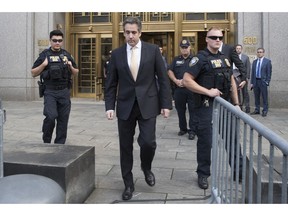 In this Aug. 21, 2018, photo, Michael Cohen, center, leaves federal court in New York. President Donald Trump has long demanded loyalty from his friends and associates. But he has been learning the hard way that in politics those relationships come and go. A key defection came this week when Cohen, Trump's former personal attorney, implicated the president in a stunning plea deal, followed by a longtime friend and media boss cooperating with prosecutors.