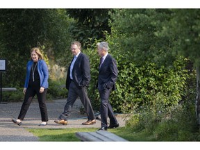 Esther George, left, President and CEO of the Federal Reserve Bank of Kansas City, John Williams, center, President and CEO of the Federal Reserve Bank of New York, and Jerome Powell, Chairman of the Board of Governors of the Federal Reserve System walk together after Powell's speech at the Jackson Hole Economic Policy Symposium on Friday, Aug. 24, 2018 in Jackson Hole, Wyo. Federal Reserve Chairman Jerome Powell signaled Friday that he expects the Fed to continue gradually raising interest rates if the U.S. economic expansion remains strong.