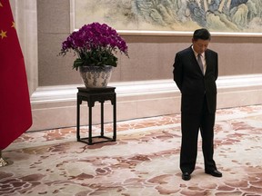 FILE - In this June 21, 2018, file photo, China's President Xi Jinping waits for the arrival of Papua New Guinea Prime Minister Peter O'Neill prior to a meeting at the Diaoyutai State Guesthouse in Beijing. Just months after clearing the way to rule in perpetuity president and ruling Communist Party leader Xi Jinping is best by a wave of economic, foreign policy and domestic political challenges.