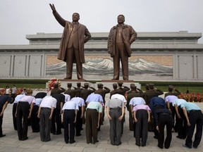 North Korean soldiers salute as others bow before the giant bronze statues of late North Korean leaders Kim Il Sung and his son Kim Jong Il during the anniversary of the end of World War II and liberation from Japanese colonial rule in Pyongyang, North Korea Wednesday, Aug. 15, 2018. North Korea has marked the anniversary with a series of ceremonies ahead of what is expected to be a much bigger event next month, the 70th anniversary of its national foundation day.