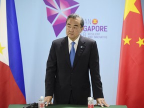 China's Foreign Minister Wang Yi pauses before a bilateral meeting with Philippines' Foreign Affairs Secretary Alan Cayetano on the sidelines of the 51st ASEAN Foreign Ministers Meeting in Singapore, Thursday, Aug. 2, 2018.