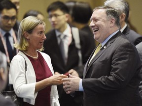 U.S. Secretary of State Mike Pompeo , right, speaks to European Union's Foreign Policy Chief Federica Mogherini ahead of the at the 25th ASEAN Regional Forum Retreat in Singapore, Saturday, Aug. 4, 2018.