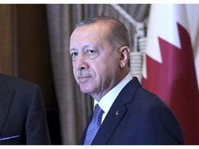 Turkey's President Recep Tayyip Erdogan, as he shakes hands with Qatar's Emir Sheikh Tamim bin Hamad Al Thani prior to their talks at the Presidential Palace in Ankara, Turkey, Wednesday, Aug. 15, 2018. Turkey said Wednesday it is increasing tariffs on some U.S. products like cars, alcohol, and coal _ a move that is unlikely to have much economic impact but highlights the deteriorating relations with the U.S. in a feud that has already helped trigger a currency crisis. (Presidential Press Service via AP, Pool)