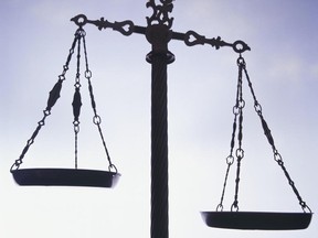 Local Input~ Silhouette of weighing scales, outdoors, scales of justice. Getty Images FOR NATIONAL POST USE ONLY