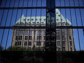 Parliament Hill is reflected in the windows of the Bank of Canada building.