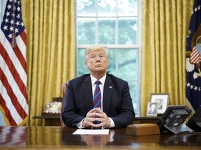 In this file photo taken on August 27, 2018, U.S. President Donald Trump listens during a phone conversation with Mexico's President Enrique Pena Nieto on trade in the Oval Office of the White House in Washington, DC.