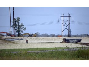 In this Sunday, Sept. 16, 2018 photo. released by Cape Fear River Watch, gray water containing coal ask flows from a ruptured landfill at the L.V. Sutton Power Station in Wilmington, N.C., and flows toward Sutton Lake, near the Cape Fear River. Duke Energy says it's initial estimate is that about 2,000 cubic yards (1,530 cubic meters) of ash were displaced at the landfill, enough to fill about 180 dump trucks. The photo was taken by Kemp Burdette with the Cape Fear River Watch, an environmental advocacy group.
