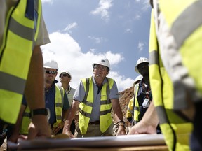 Mark Bristow, chief executive officer of Randgold Resources Ltd., center, listens to a briefing by members of his mining team in the open pit at the Kibali gold mine in Kibali, Democratic Republic of Congo in 2014.