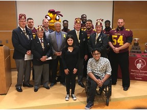The Karnak Shriners were proud to welcome the Concordia Stingers to Shriners Hospitals for Children – Canada. From left to right: Mike Keys, Chairman of the Shrine Bowl; Michael Sanelli, Concordia Stingers #95; Norton Paish, Karnak Shriners and emcee; Brad Collinson, Head Coach of the Concordia Stingers; Gerry McGrath, Honorary Chairman; Jersey Henry, Concordia Stingers #10; Victoria, Shrine Bowl Queen; David Merrett, Vice-Chairman of the Board of Governors, Shriners Hospitals for Children – Canada; Maurice Simba, Concordia Stingers # 78; Brandon Pacheco, Concordia Stingers #52; Gary McKeown, Potentate, Karnak Shriners; Saoud (in front), Shrine Bowl King; Khadeem Pierre, Concordia Stingers #5; Marc-Antoine Sévigny, Concordia Stingers #54.