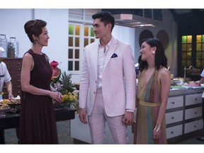 This image released by Warner Bros. Entertainment shows Michelle Yeoh, from left, Henry Golding and Constance Wu in a scene from the film "Crazy Rich Asians."