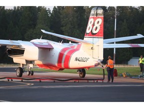 Cal Fire's Melody Brown helps reload tanker 88 with retardant Monday evening, Sept. 3, 2018, during her first season at the Grass Valley Air Attack Base. Thirty thousand gallons of retardant was administered to 4 air tankers Monday for the North Fire.