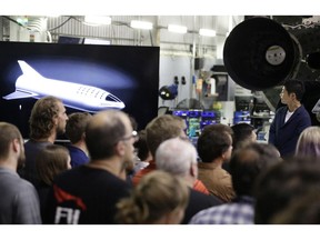 Japanese billionaire Yusaku Maezawa, right, looks at a monitor showing the BFR spacecraft after SpaceX founder and chief executive Elon Musk announced him as the first scheduled private passenger on a trip around the moon, Monday, Sept. 17, 2018, in Hawthorne, Calif.