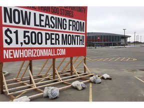 The developer of a nearly empty new mall just north of Calgary says he's confident it will become the bustling Asian-style bazaar it's meant to be despite having to delay its late-October grand opening until sometime next year. A sign is seen outside of the New Horizon shopping mall in Balzac, Alta., north of Calgary on Thursday, Sept. 20, 2018.