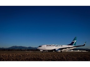 A Westjet Boeing 737-700 taxis to a gate after arriving at Vancouver International Airport in Richmond, B.C., on February 3, 2014. An RBC survey says airfares are tracking up more than 10 per cent in the third quarter at Air Canada and WestJet despite slipping a bit August. Fares rose 12.5 per cent at Air Canada for July and August and were 11.3 per cent higher than a year earlier at WestJet.