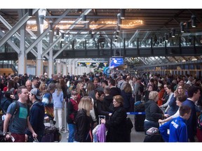 Hundreds of passengers wait in a lineup at Vancouver International Airport in Richmond, B.C., on Saturday April 1, 2017. A J.D. Power survey says Canada's three largest airports scored above the North American average by passengers. Vancouver International led, scoring 781 on a 1,000-point scale that measured satisfaction with check-in; food, beverage and retail; accessibility; terminal facilities and baggage claim.THE CANADIAN PRESS/Darryl Dyck