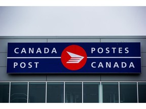 The Canada Post logo is seen on the outside the company's Pacific Processing Centre, in Richmond, B.C., on Thursday June 1, 2017. An arbitrator has released a ruling in a long-standing pay equity dispute at Canada Post that gives rural carriers a hefty pay increase.