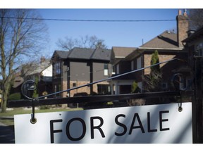 A sold sign is shown in front of west-end Toronto homes Sunday, April 9, 2017. Real estate companies that were promised access to a Toronto Real Estate Board feed of Greater Toronto Area home sales data on Tuesday say they're still waiting to get their hands on the numbers.