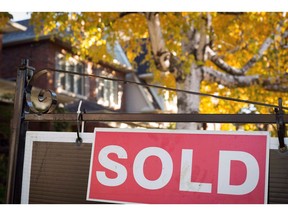 A real estate sold sign hangs in front of a west-end Toronto property Friday, Nov. 4, 2016. The Toronto Real Estate Board says it is still reviewing a handful of issues associated with releasing Greater Toronto Area sales data, but it will make a password-protected feed with the numbers available to realtors by Sept. 18.