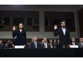 Facebook COO Sheryl Sandberg, left, accompanied by Twitter CEO Jack Dorsey are sworn in before the Senate Intelligence Committee hearing on 'Foreign Influence Operations and Their Use of Social Media Platforms' on Capitol Hill, Wednesday, Sept. 5, 2018, in Washington.