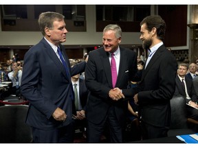 Senate Intelligence Committee Vice Chairman Mark Warner, D-Va., left, and Chairman Sen. Richard Burr, R-N.C., center, greet Twitter CEO Jack Dorsey before he testifies before the Senate Intelligence Committee hearing on 'Foreign Influence Operations and Their Use of Social Media Platforms' on Capitol Hill, Wednesday, Sept. 5, 2018, in Washington.