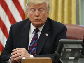 U.S. President Donald Trump speaks on the telephone via speakerphone with Mexican President Enrique Pena Nieto to announce that the two countries had reached a preliminary trade agreement on Aug. 27.