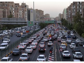 In this Monday, Sept. 17, 2018 photo, vehicles are stuck in a traffic jam in southern Tehran, Iran. As Iran's rial currency suffers precipitous falls against the U.S. dollar, cars are growing more and more expensive. That's a problem for one of the Mideast's biggest countries and home to 80 million people.