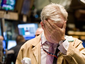 Trader David O'Day rubs his eyes as he works on the floor of the New York Stock Exchange on Sept. 29, 2008. Ten years after the collapse of Lehman Bros., there are still lessons to be learned.