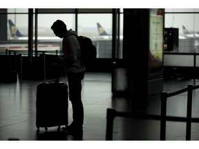 A passenger stands in front of Ryanair airline check-in desks during a Ryanair employees strike at the Charleroi airport, outside Brussels, Friday, Sept. 28, 2018. Ryanair pilots and cabin crew went on strike forcing the cancellation of some 250 flights across Europe, including Spain, Portugal, Belgium, the Netherlands, Italy and Germany.