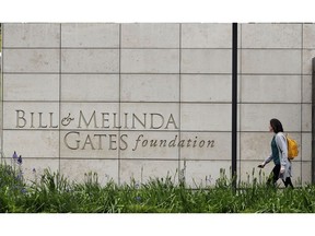 FILE - In this April 27, 2018, file photo, a person walks by the headquarters of the Bill and Melinda Gates Foundation in Seattle. Bill Gates is rallying behind school quality in developing nations with a push for more assessment data, a new initiative that links the Microsoft co-founder's signature U.S. education priorities with his more prominent global philanthropy work. The Bill and Melinda Gates Foundation as the world's largest philanthropy issued its latest "Goalkeepers" report on Tuesday, Sept. 18, 2018, urging for more comparable student assessment data worldwide and getting girls through their schooling.