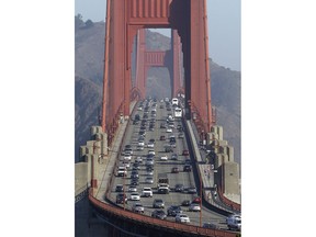 FILE - In this Sept. 19, 2013 file photo, automobile traffic flows over the Golden Gate Bridge in San Francisco. Doctors and California officials will be among those weighing in on the Trump administration's proposal to roll back car-mileage standards at a hearing Monday, Sept. 24, 2018, in a region with some of the nation's worst air pollution. The proposal would freeze U.S. mileage standards at levels mandated by the Obama administration for 2020 instead of letting them rise to 36 miles per gallon by 2025.