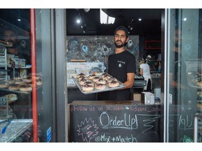 Jiten Grover, owner of Dipped Donuts, displays a new batch of donuts after nearly selling out by the afternoon in Toronto, Wednesday, September 12, 2018. As Jiten Grover prepared to open his first Dipped Donuts storefront in Toronto, he knew the power social media stars possess to boost the profile of a business in the food industry.When Grover opened the doors to the doughnut shop earlier this summer, a self-proclaimed local foodie posted a photo and rave review after trying the new spot. A prominent local blog reposted her snap and nearly 3,000 people proceeded to like it.